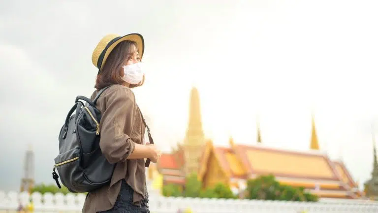 Woman traveling Thailand with a mask on