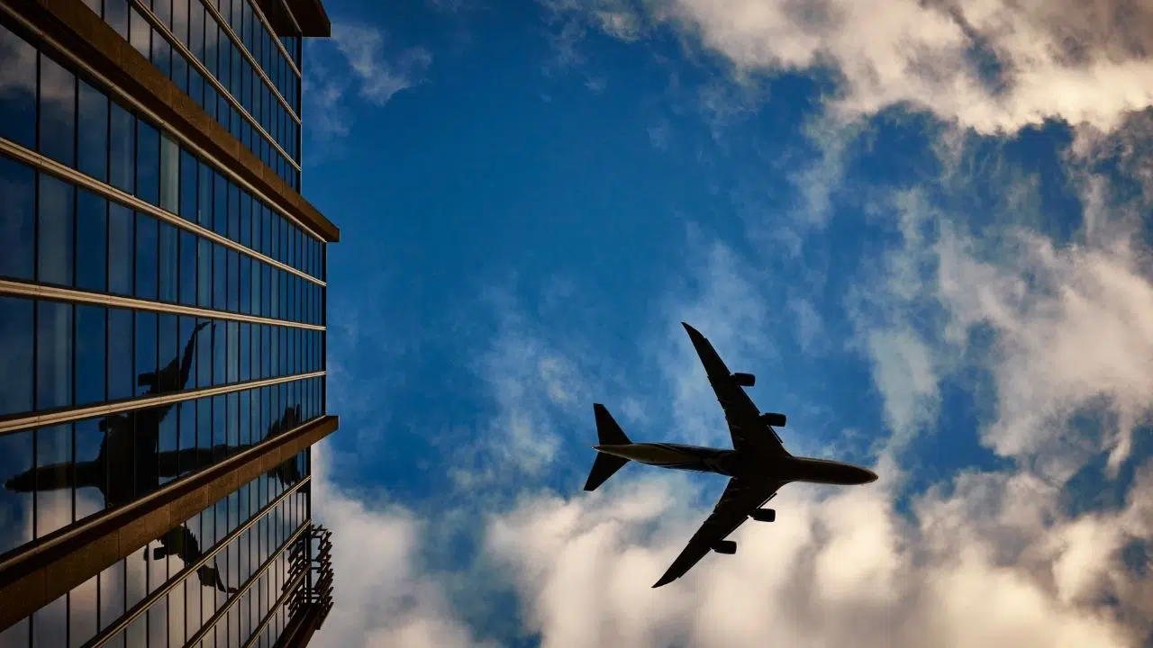 plane-blue-sky-building