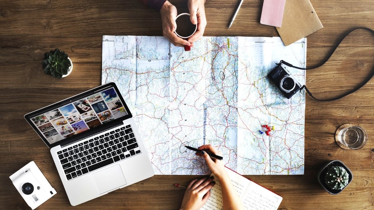 couple-planning-vacation-travel-map
