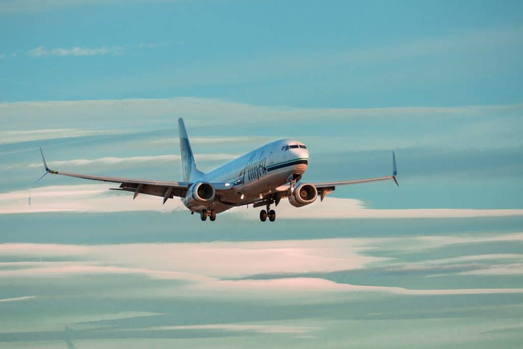 An Airplane fills a blue sky - cheap flights online