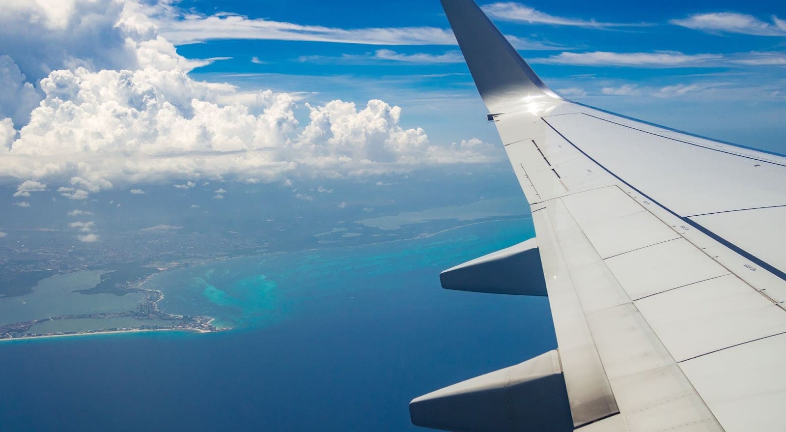 Plane wing flying past Cancun