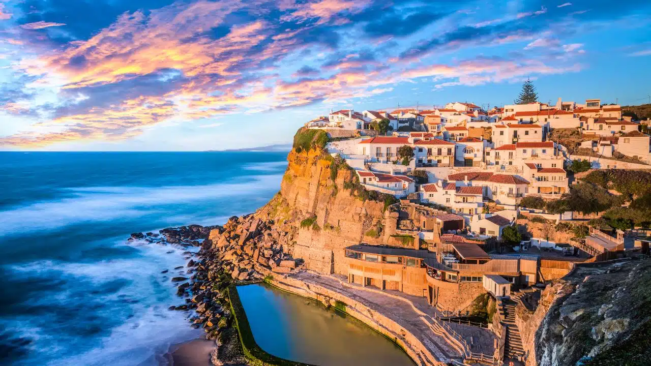 Aerial view of Azenhas Do Mar during sunset with natural pool in view