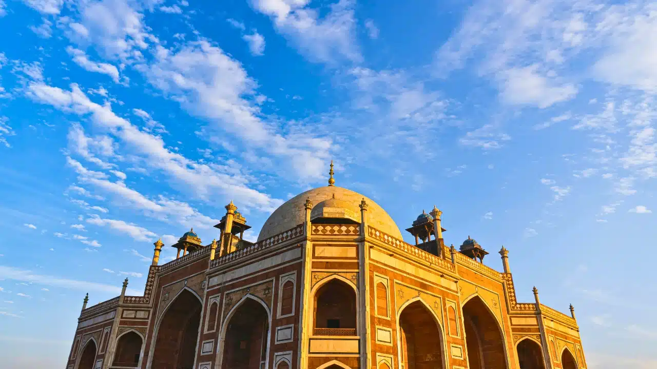 Humayun's Tomb in Delhi, India, displaying magnificent Mughal architecture, a white marble dome, and historic sandstone details, making it one of Delhi's top cultural and UNESCO World Heritage attractions.