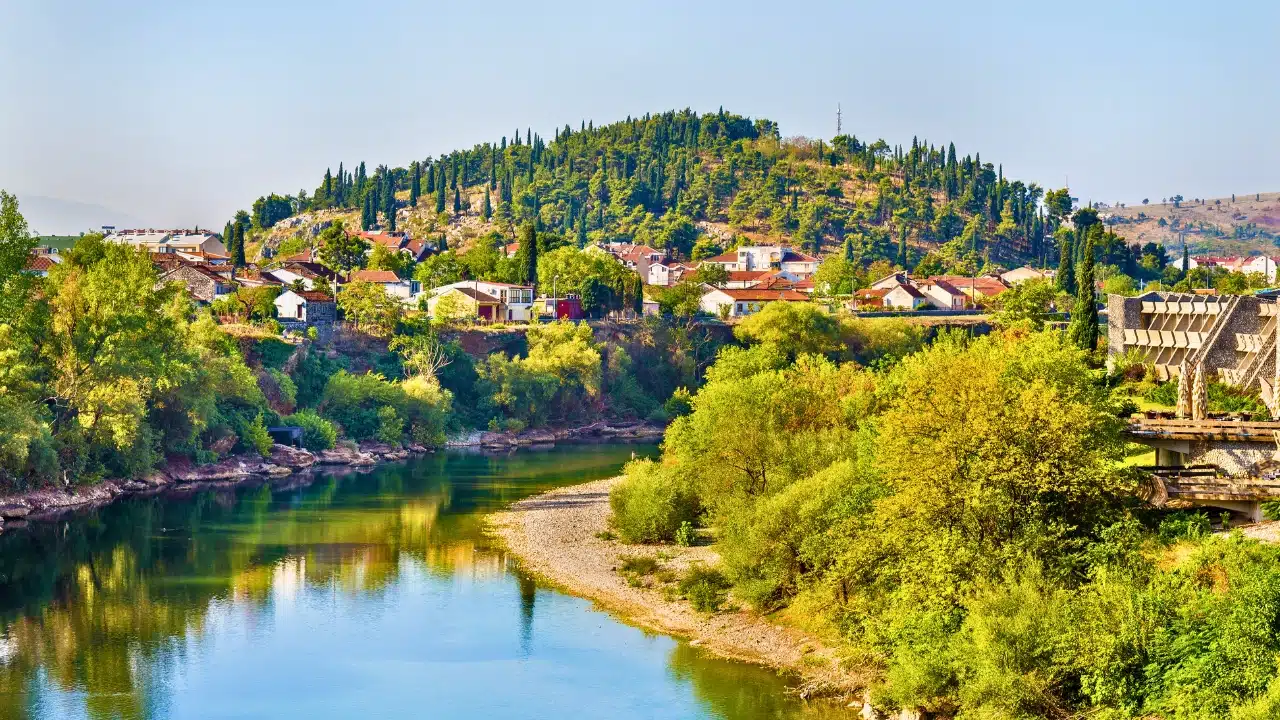 Scenic panorama of Podgorica, Montenegro, showcasing the Morača River, green landscapes, peaceful hillside neighborhoods, and the city's natural beauty, making it an ideal destination for nature and cultural exploration.